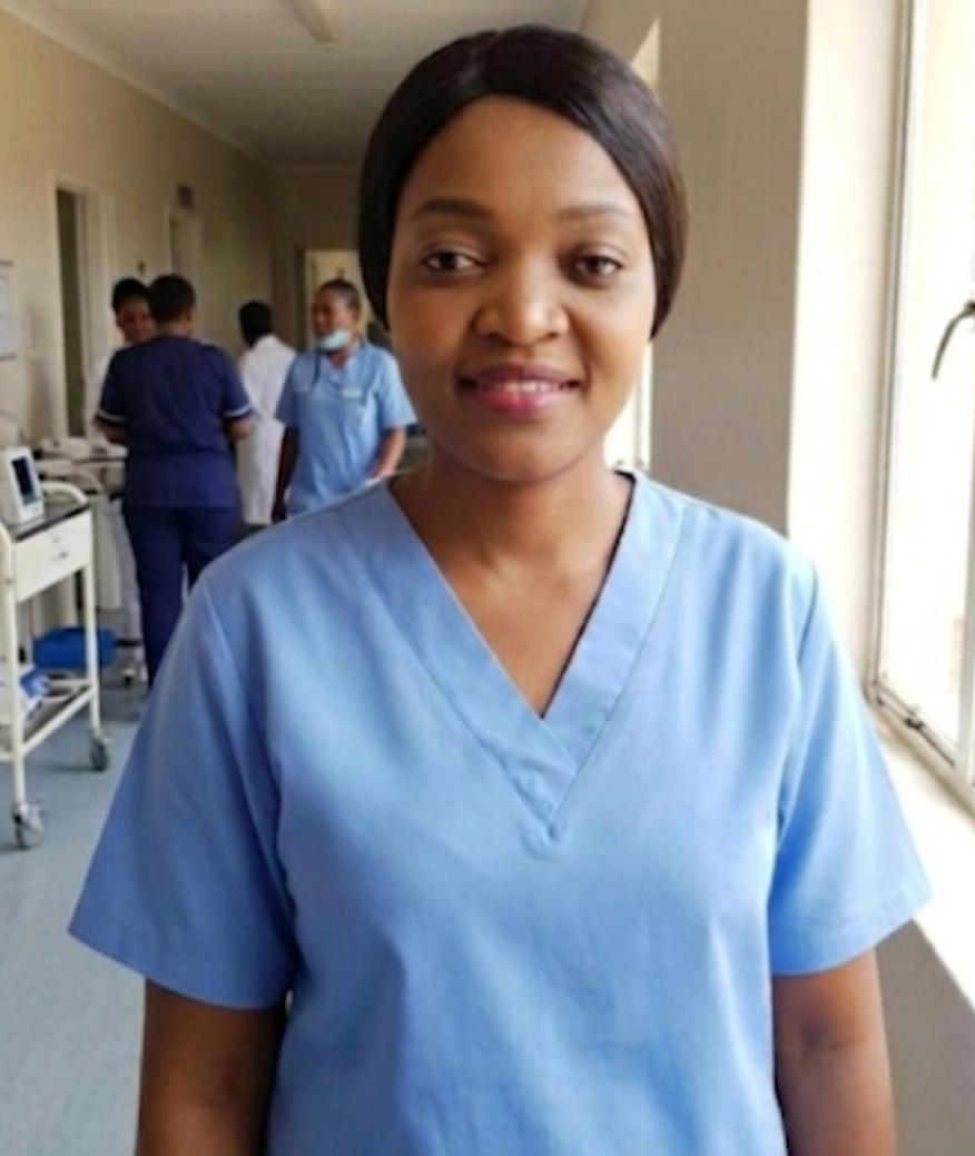 Portrait of Anita, Co-Founder and Care Partner at Graceful Hands Care, in professional light blue scrubs